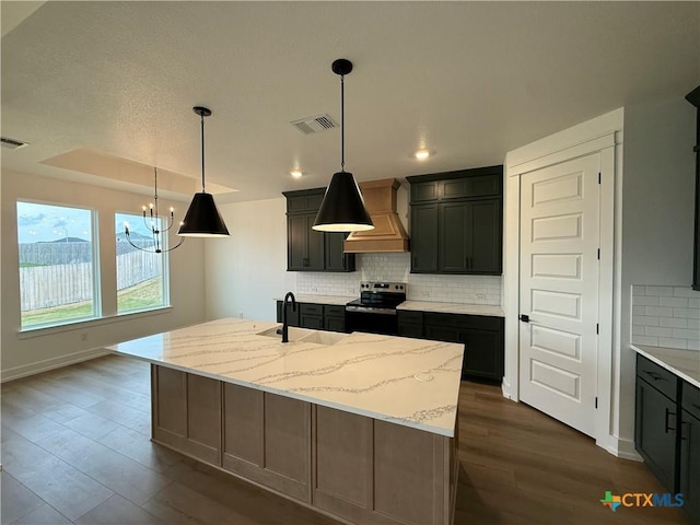 4146 Turning Leaf Dr, Nolanville, TX 76559 - kitchen with electric range, an inviting chandelier, a sink, premium range hood, and backsplash
