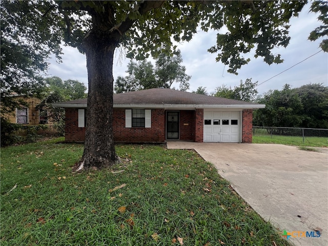 single story home featuring a garage and a front yard