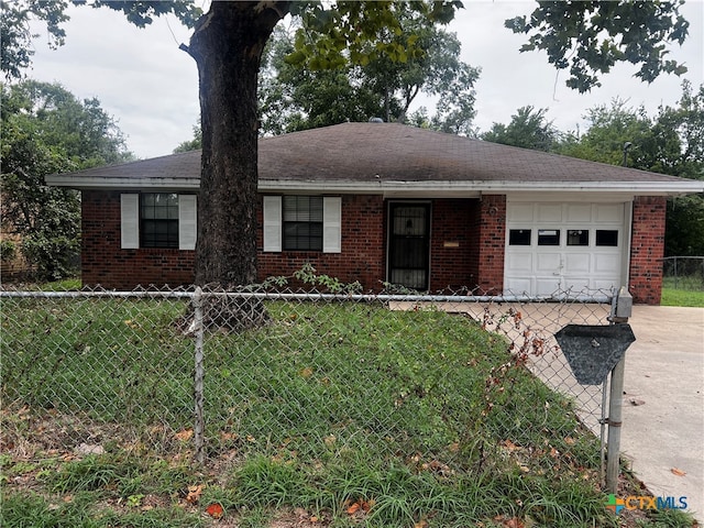 single story home featuring a garage and a front yard