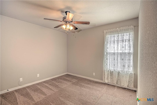 carpeted empty room featuring a ceiling fan, baseboards, and a textured ceiling