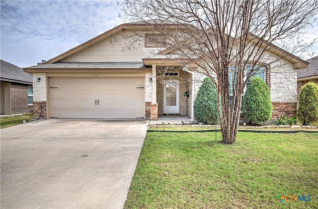 view of front of property with an attached garage, a front lawn, concrete driveway, stone siding, and brick siding