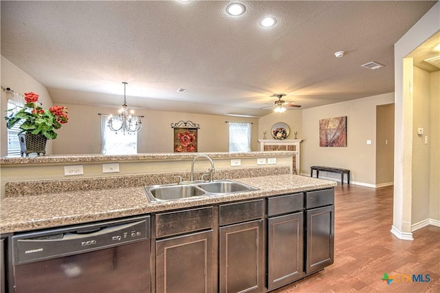 kitchen with visible vents, light wood-type flooring, a sink, a textured ceiling, and dishwasher