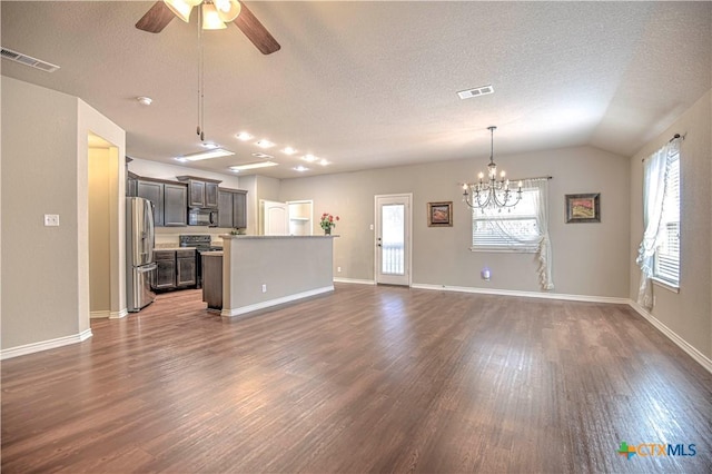 unfurnished living room featuring visible vents, plenty of natural light, and dark wood-style flooring