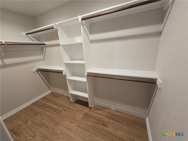 spacious closet featuring hardwood / wood-style flooring