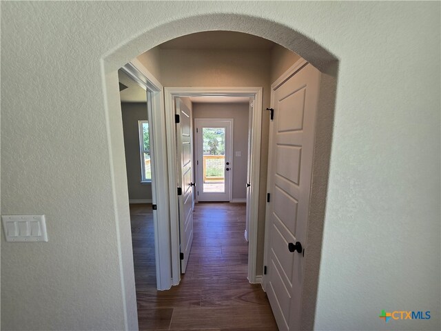 hall with dark hardwood / wood-style flooring