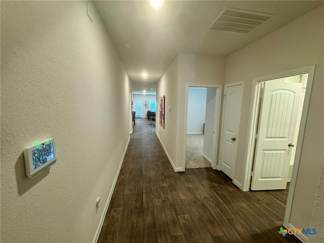 408 St Thomas St, Lockhart, TX 78644 - corridor featuring dark wood-type flooring and baseboards