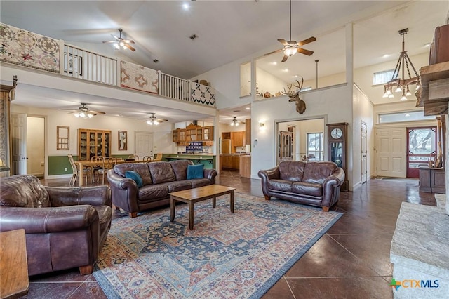 tiled living room featuring a towering ceiling and ceiling fan