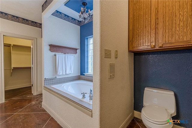 bathroom featuring a tub, tile patterned floors, and toilet