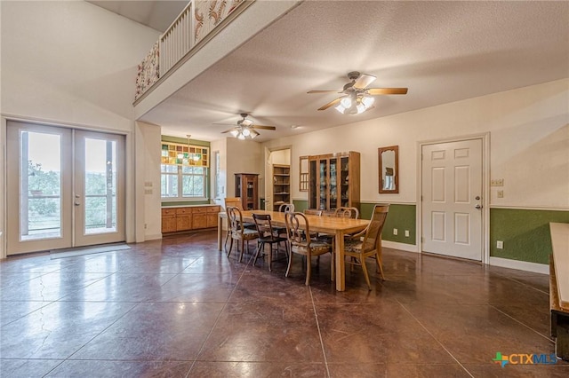 tiled dining area with french doors, ceiling fan, and a textured ceiling