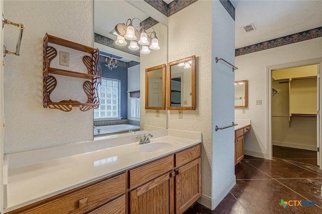 bathroom with tile patterned flooring, vanity, and a bathtub