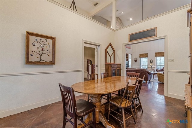 dining space with a towering ceiling