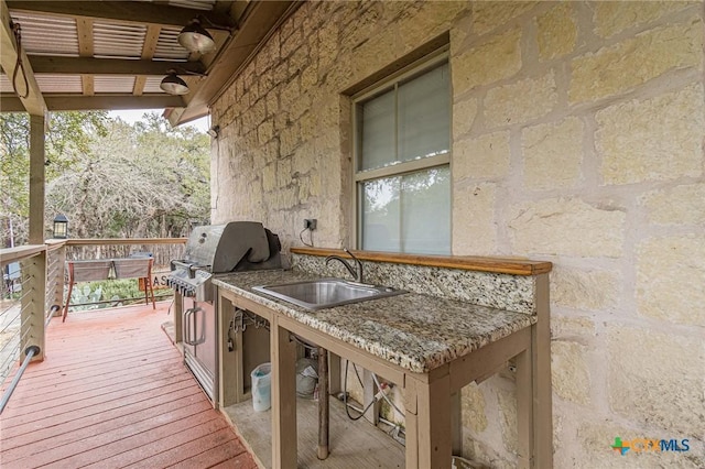 wooden deck featuring an outdoor wet bar and grilling area