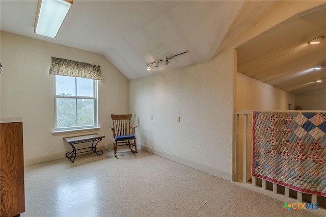 living area featuring lofted ceiling and rail lighting