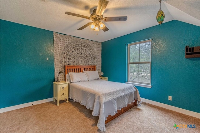 carpeted bedroom with vaulted ceiling, ceiling fan, and a textured ceiling