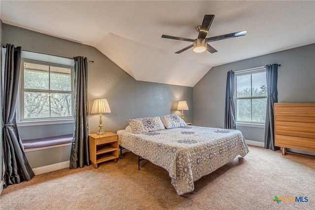 carpeted bedroom featuring vaulted ceiling and ceiling fan