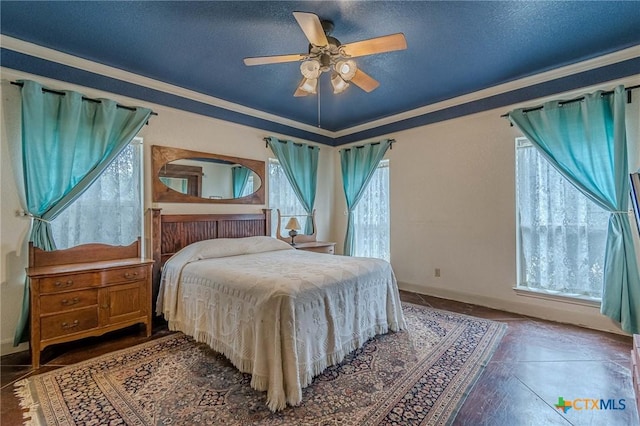 bedroom featuring crown molding, ceiling fan, and a textured ceiling