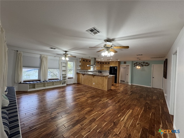 kitchen with freestanding refrigerator, dark wood-style flooring, ceiling fan, and visible vents