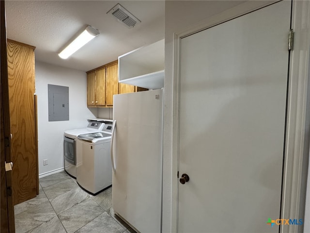 clothes washing area with electric panel, visible vents, cabinet space, baseboards, and washer and clothes dryer