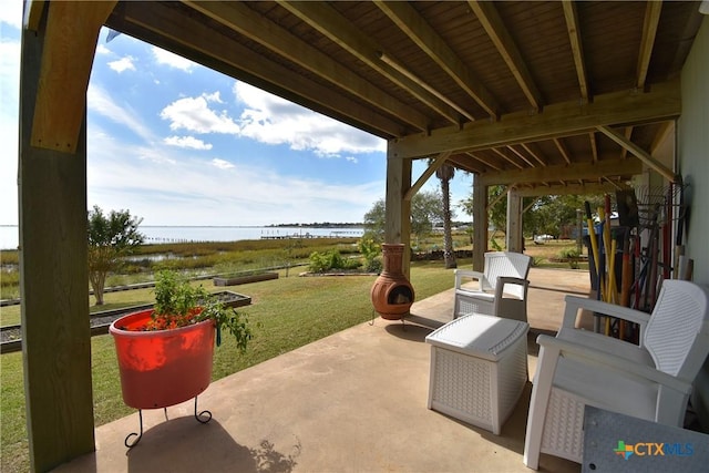 view of patio with a water view