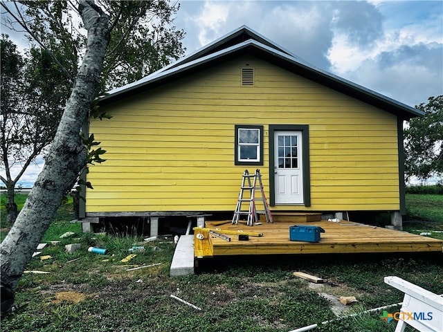 rear view of property with a wooden deck