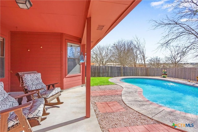 view of pool featuring a fenced backyard, a fenced in pool, and a patio