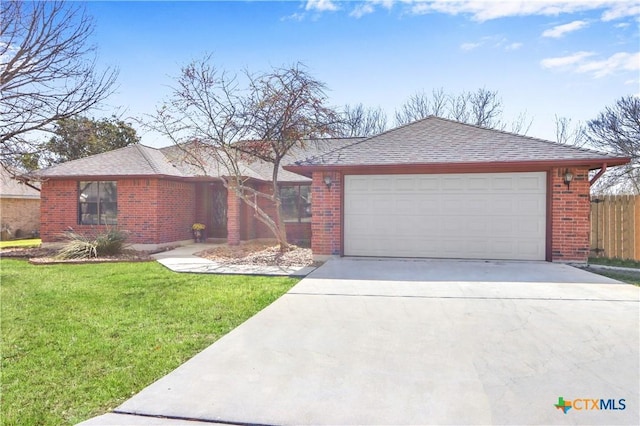 ranch-style home featuring concrete driveway, an attached garage, fence, and brick siding