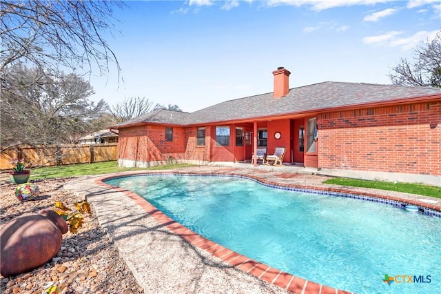 view of swimming pool featuring a patio area, a fenced in pool, and fence