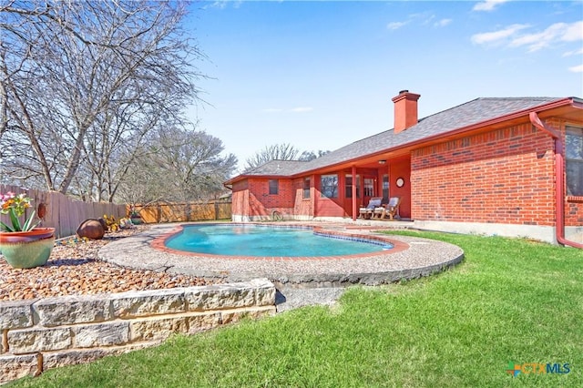 view of swimming pool with a patio, a yard, a fenced in pool, and a fenced backyard