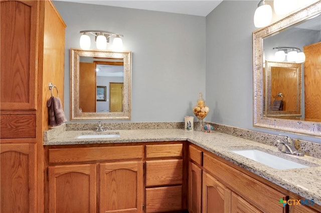 full bath featuring double vanity and a sink