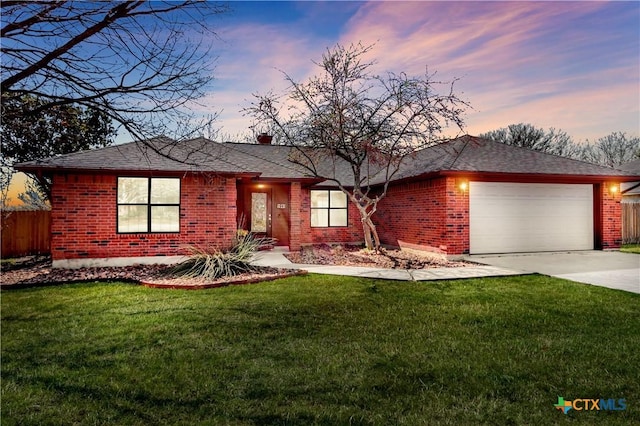 ranch-style home featuring brick siding, an attached garage, and driveway