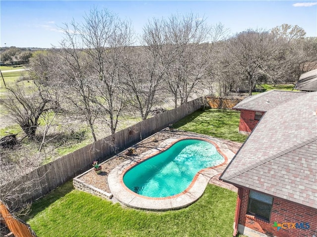 view of swimming pool featuring a yard, a fenced in pool, and a fenced backyard