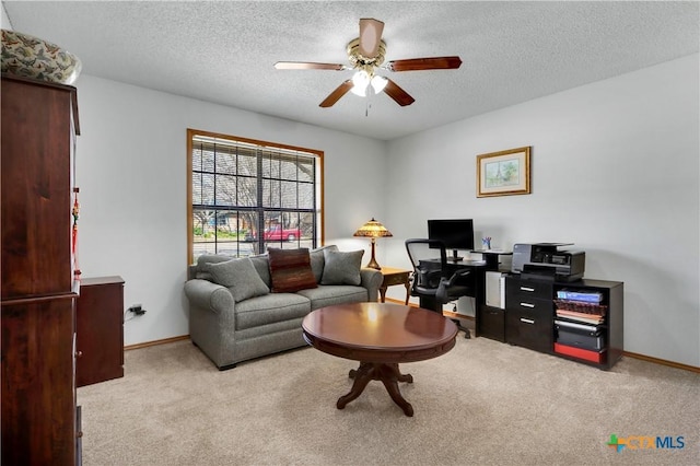 interior space with baseboards, a textured ceiling, and a ceiling fan