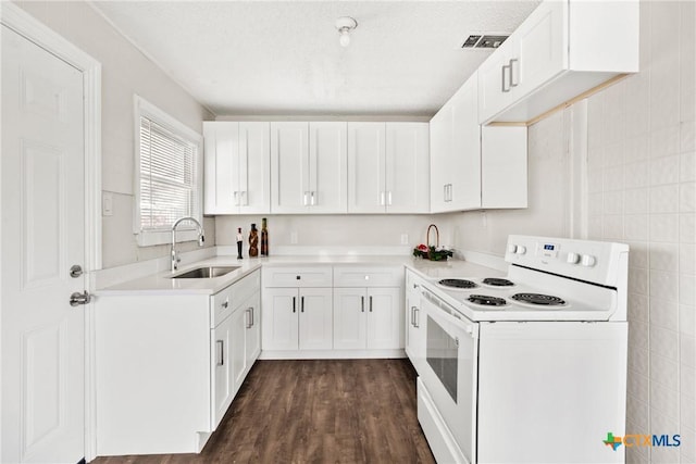 kitchen featuring white range with electric stovetop, visible vents, dark wood-style floors, light countertops, and a sink