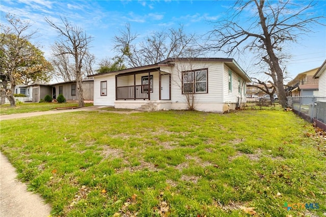 view of front of property with fence and a front lawn