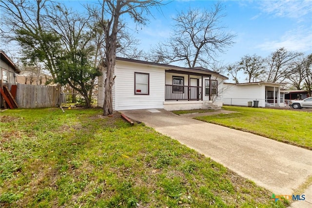 bungalow featuring a front lawn, a porch, and fence