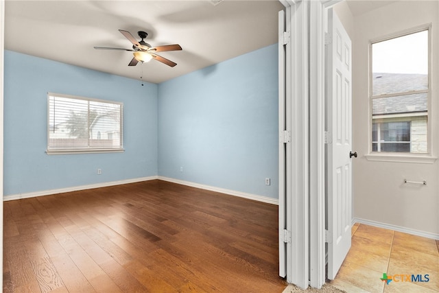 spare room featuring light wood-type flooring and ceiling fan