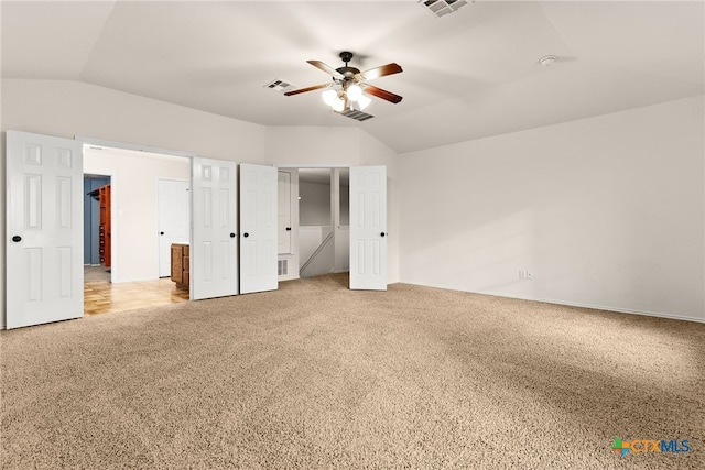 unfurnished bedroom with carpet, vaulted ceiling, and ceiling fan