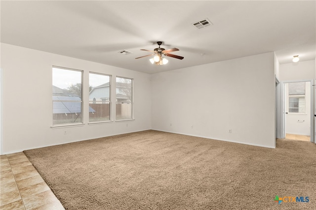 spare room featuring carpet floors and ceiling fan