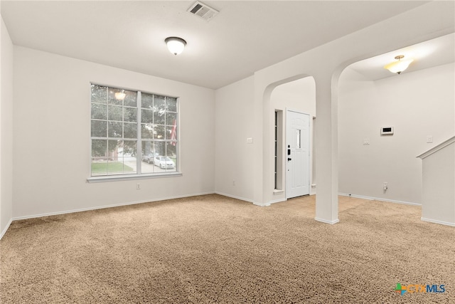 spare room with light colored carpet