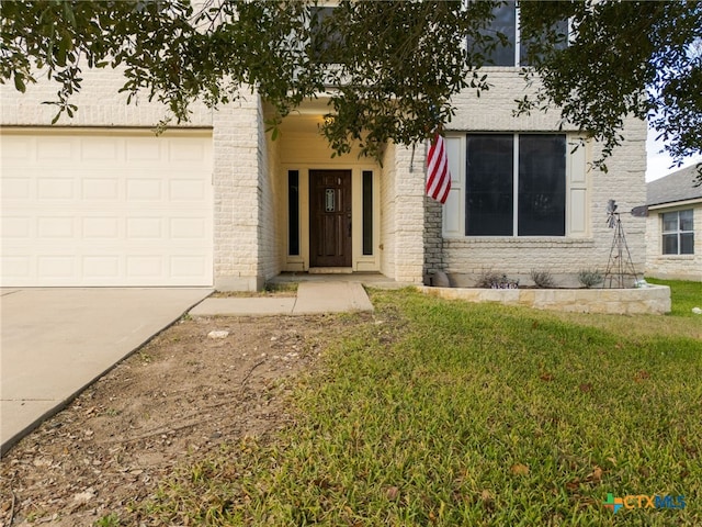 view of front of home with a garage and a front lawn