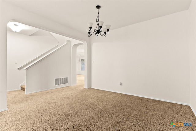 interior space featuring carpet and an inviting chandelier