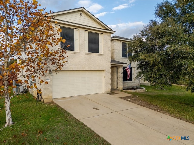 view of front of home with a garage and a front lawn