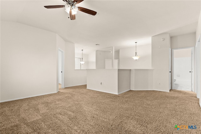 carpeted empty room with ceiling fan and lofted ceiling