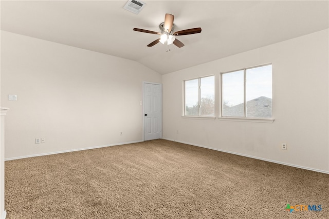 carpeted spare room featuring ceiling fan and vaulted ceiling