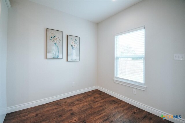 3611 Hanselman Rd, Victoria, TX 77901 - spare room featuring baseboards and dark wood-type flooring