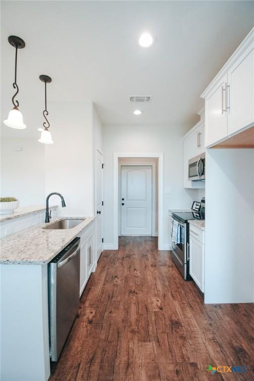 3611 Hanselman Rd, Victoria, TX 77901 - kitchen with stainless steel appliances, dark wood finished floors, white cabinets, and recessed lighting