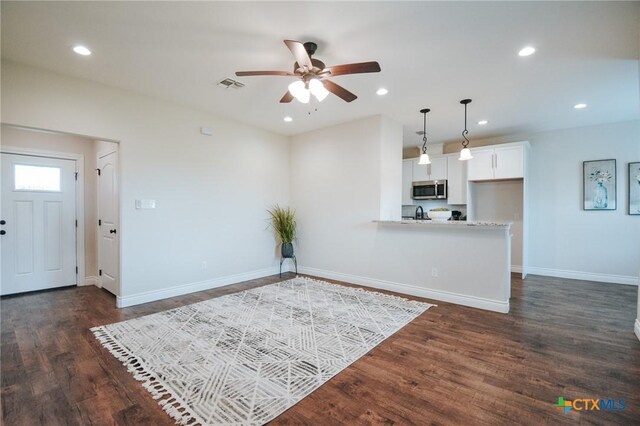 3611 Hanselman Rd, Victoria, TX 77901 - unfurnished living room featuring a ceiling fan, dark wood-style flooring, and recessed lighting