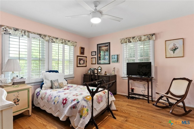 bedroom with ceiling fan and light wood-type flooring