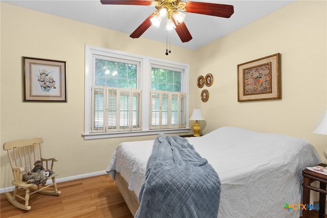 bedroom with wood-type flooring and ceiling fan