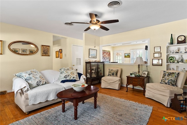 living room with hardwood / wood-style flooring and ceiling fan